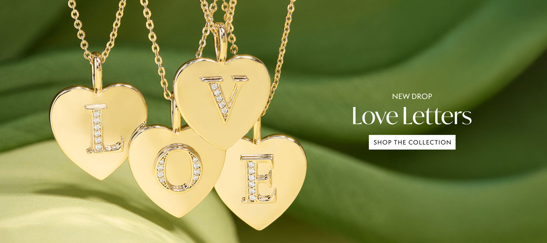 New Baby Love Letters Pendant Necklace spelling out Love on a green background