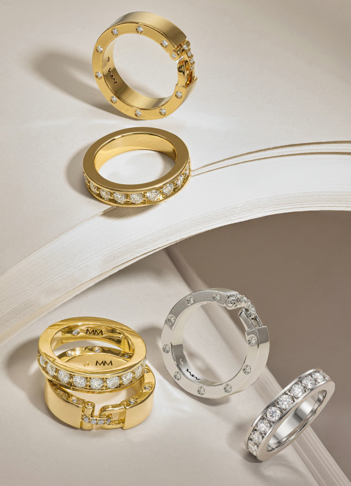 Gold and silver rings with diamond accents on a light background