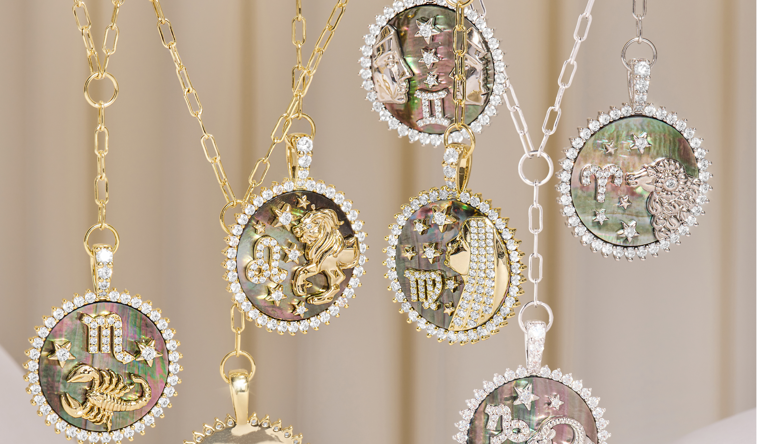 Jewelry set with zodiac-themed pendants on a neutral background