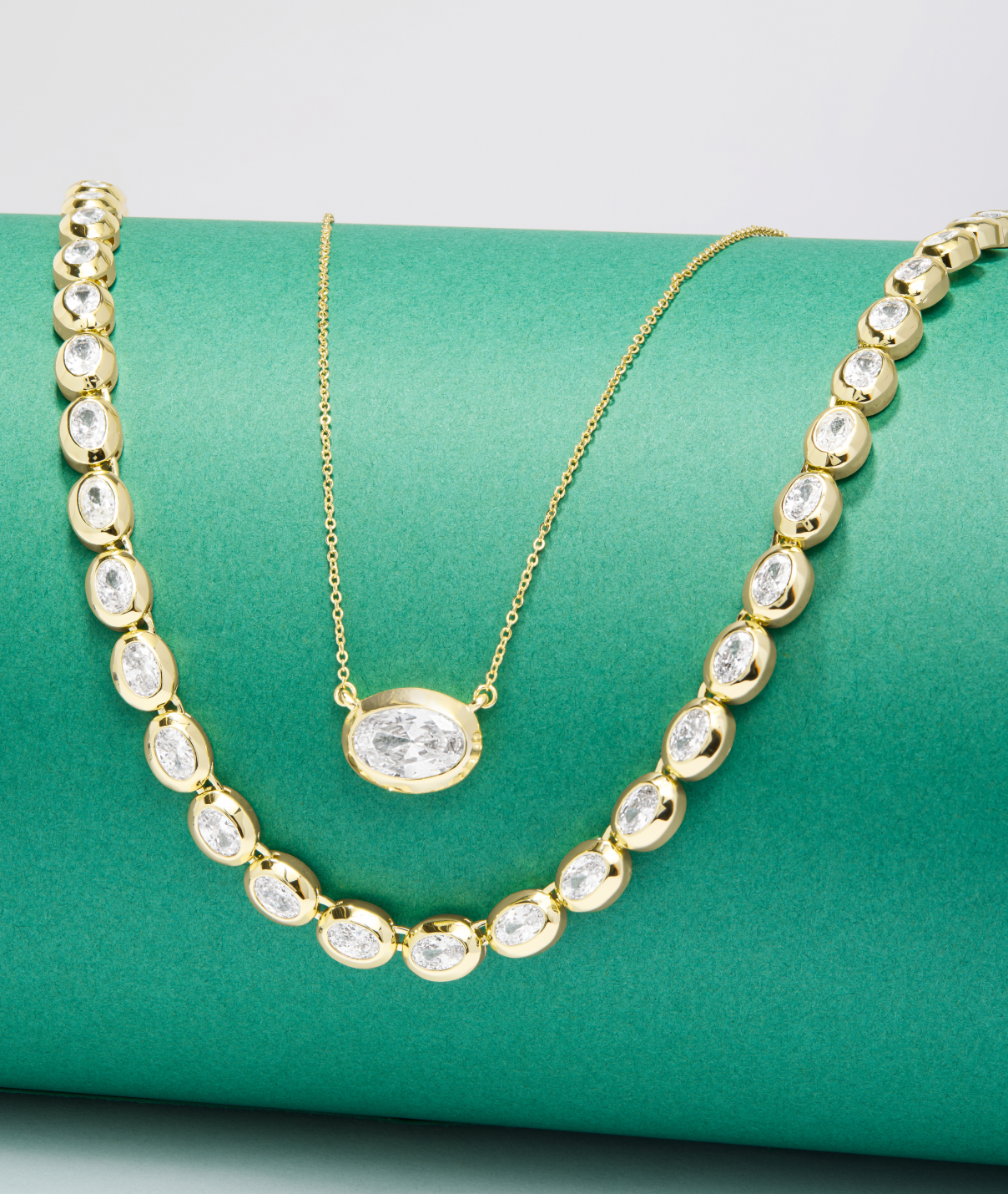 NEW She's a Boss Pendant Necklace and NEW She's a Boss Tennis Necklace on a green background