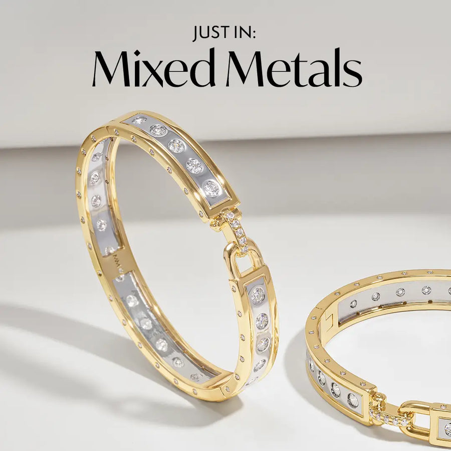 Two gold and white mixed-metal bracelets with clear rhinestones, displayed on a clean white background with the text 'JUST IN: Mixed Metals' at the top.