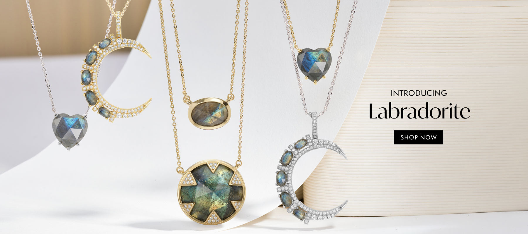 Jewelry display with necklaces featuring Labradorite stones on a light background.
