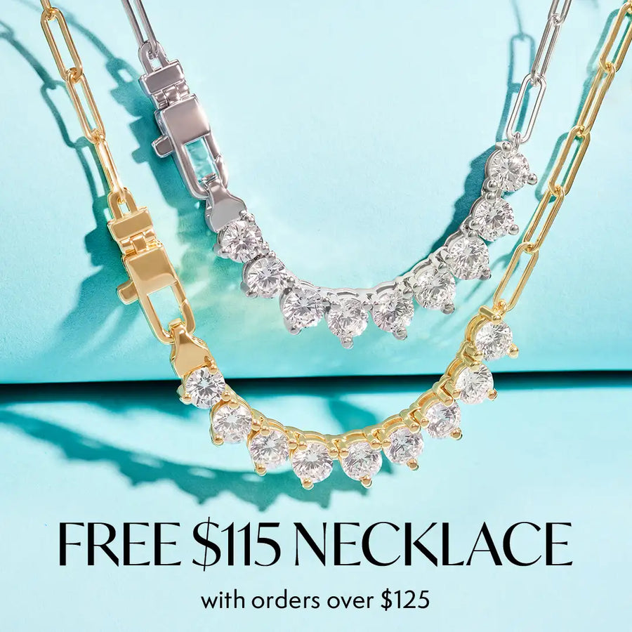 Two silver-toned necklace bracelets with clear gemstones are displayed on a light aqua background, with one gold-toned bracelet layered behind. Text at the bottom reads 'FREE $115 NECKLACE with orders over $125'.