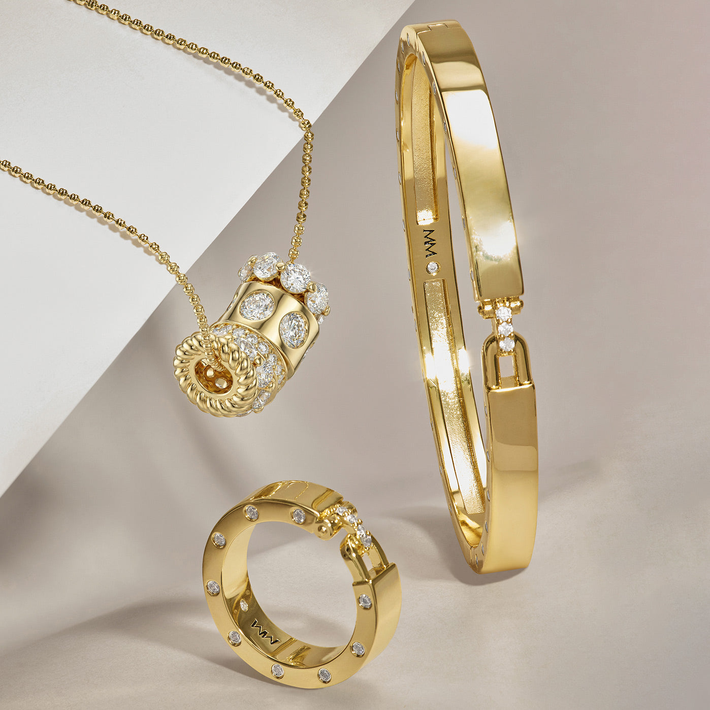 Gold jewelry set with necklace, ring, and bracelet on a neutral background