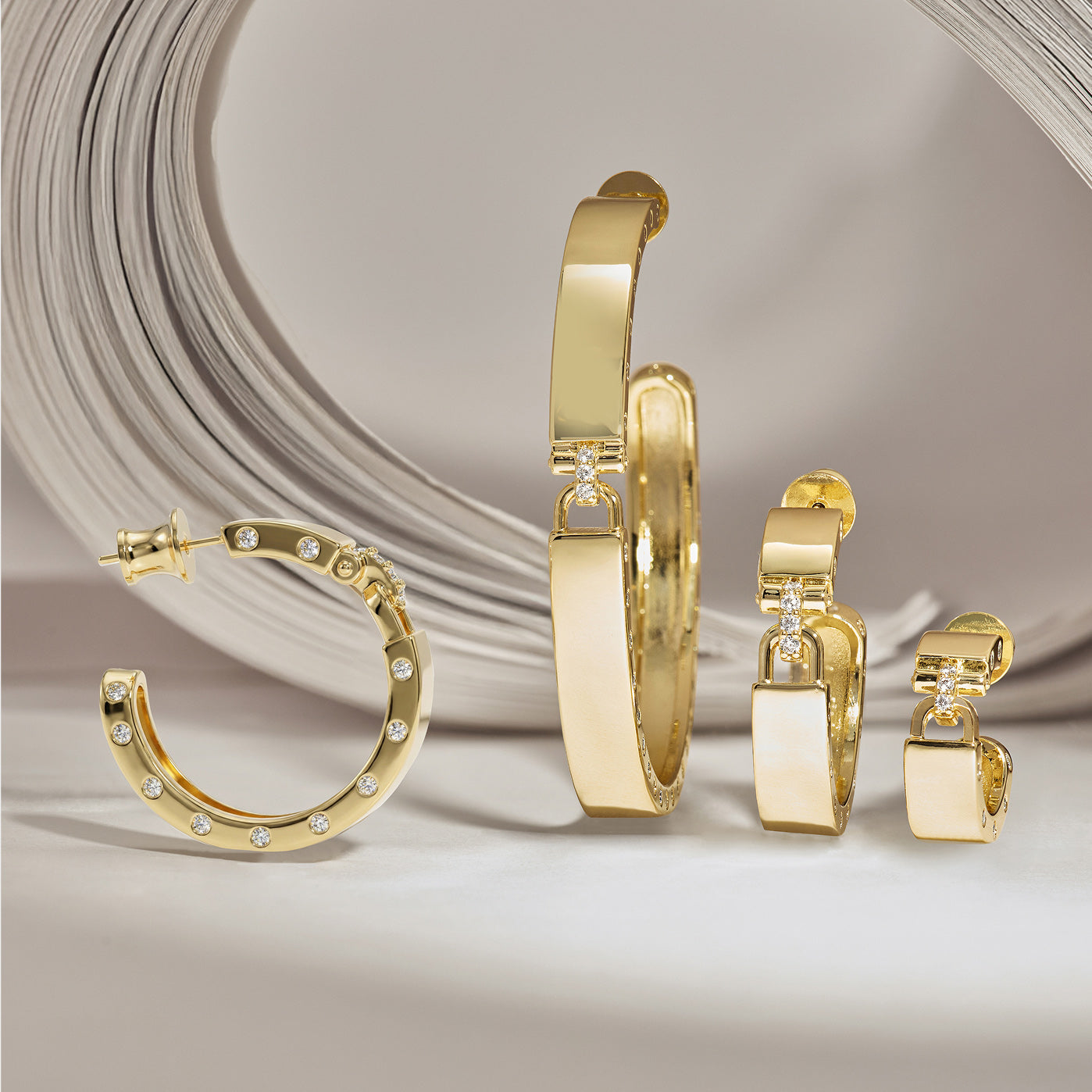 Gold hoop earrings with diamond accents on a neutral background