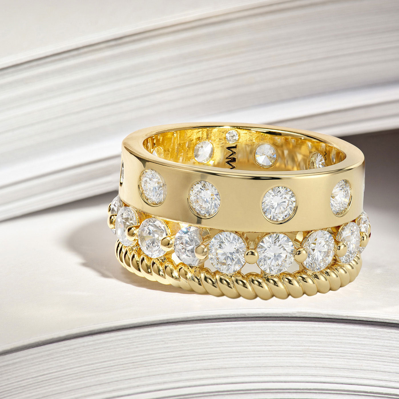 Gold ring with diamond stones on a light background