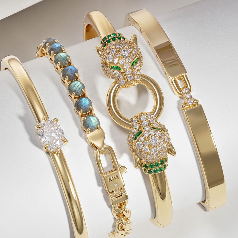 Gold jewelry set with animal-themed charms on a white background