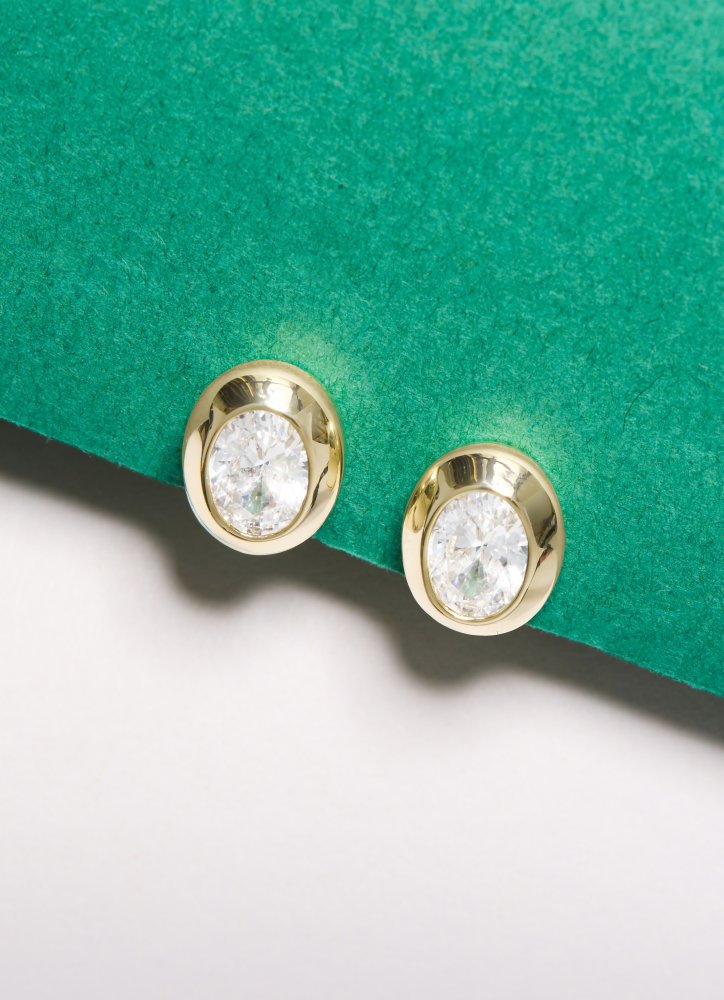 NEW She's a Boss Stud Earrings on a green and white background