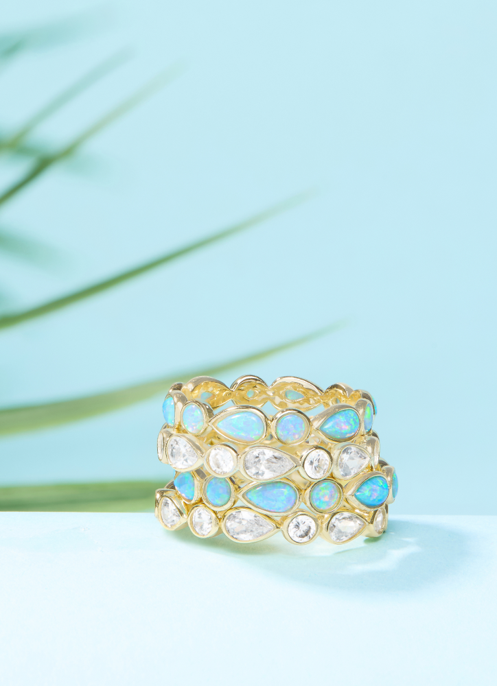 NEW Isla Rings stacked on a blue background