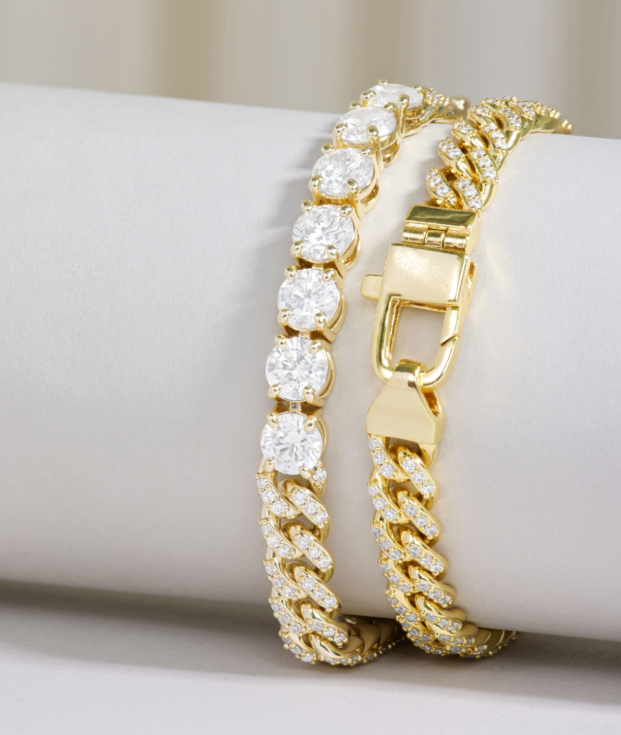 Gold bracelet with diamond accents on a white surface