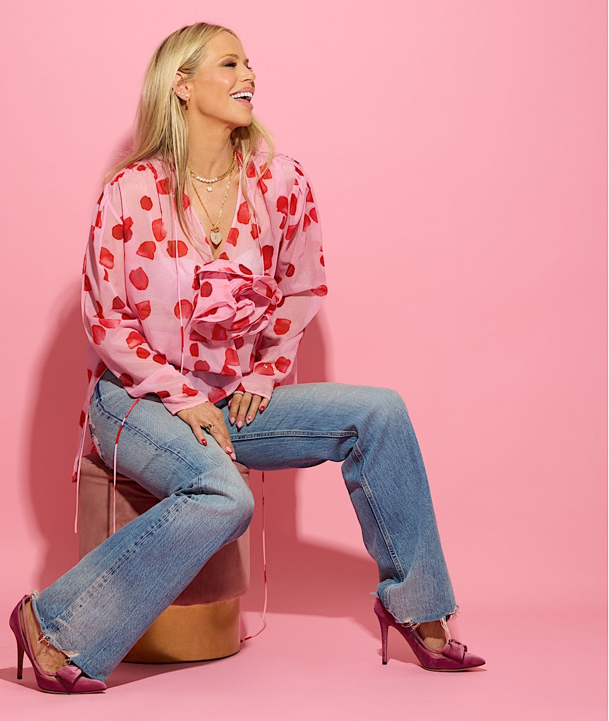 Melinda dressed in pink wearing the Love Letters Heart Medallion necklace.