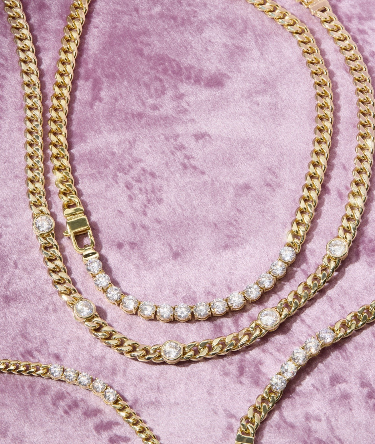 Still life of new Julian Loves Diamonds necklaces on lavender background