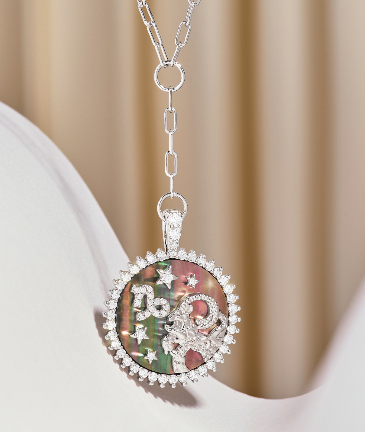 Silver necklace with a colorful pendant on a beige background