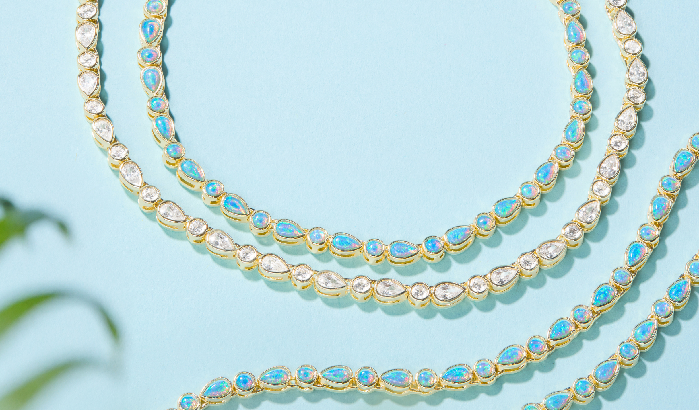 NEW Isla Tennis Necklaces on blue background