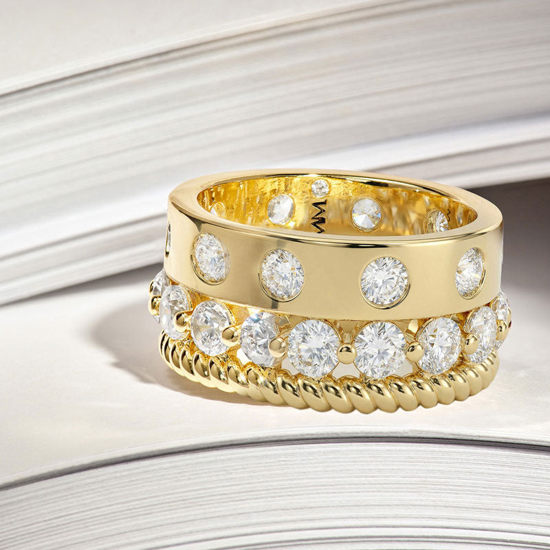 Gold ring with diamond stones on a light background