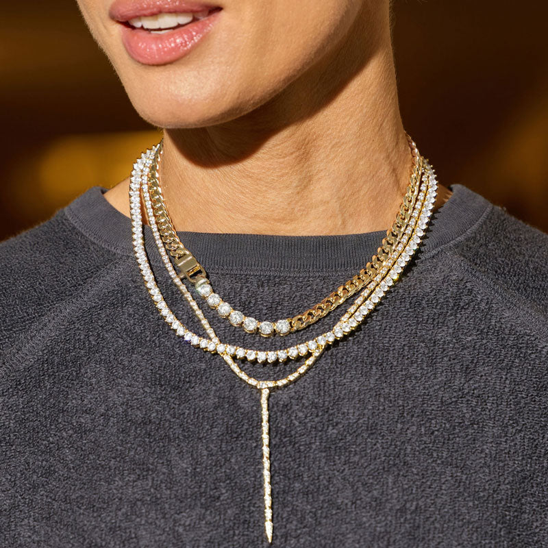 Close-up of a woman wearing multiple necklaces with a blurred background