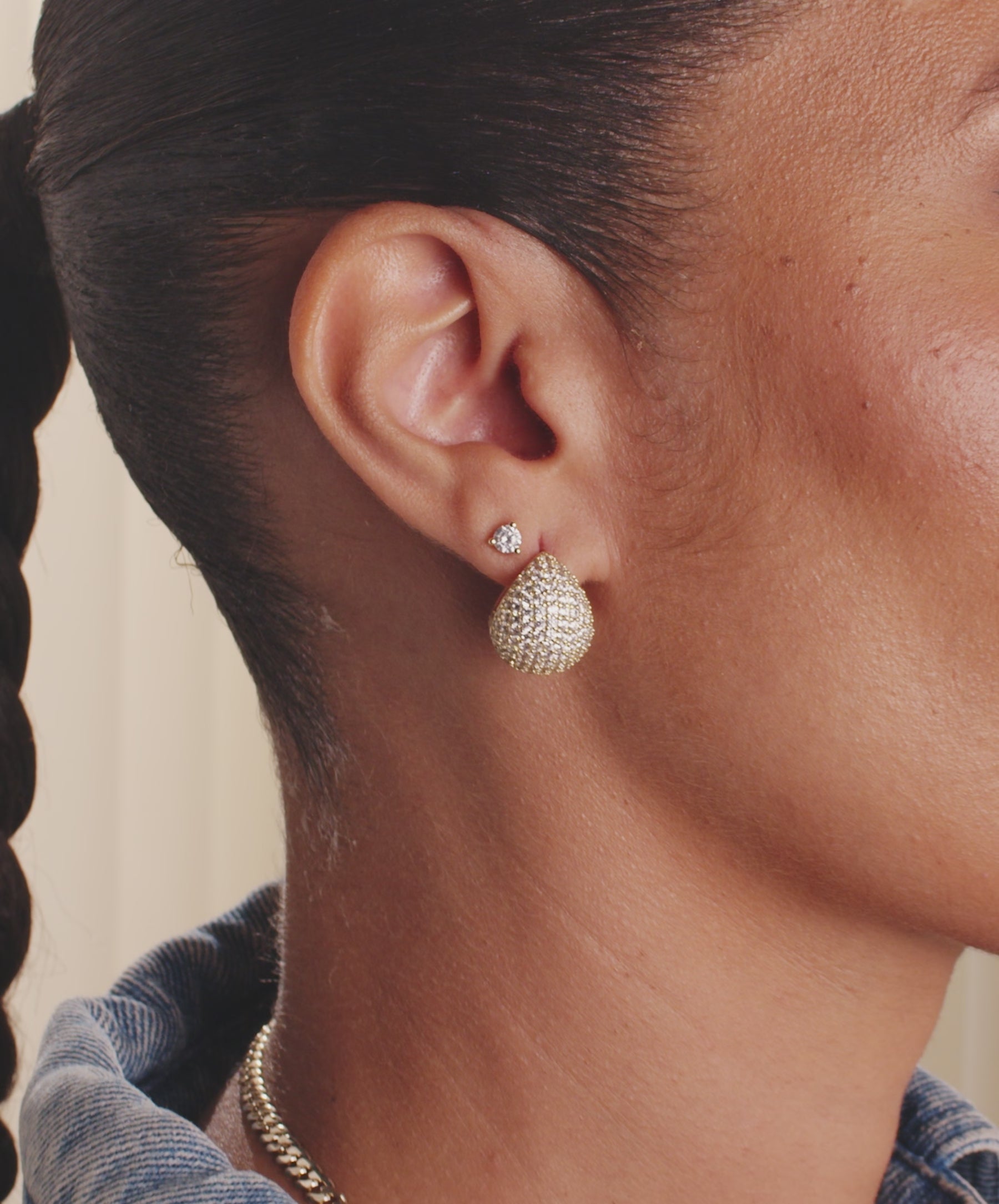 Model wearing pieces from the New Norah Collection against a cream colored background